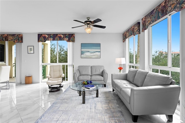 living room with ceiling fan and a wealth of natural light