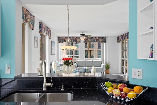 kitchen featuring sink and ceiling fan with notable chandelier