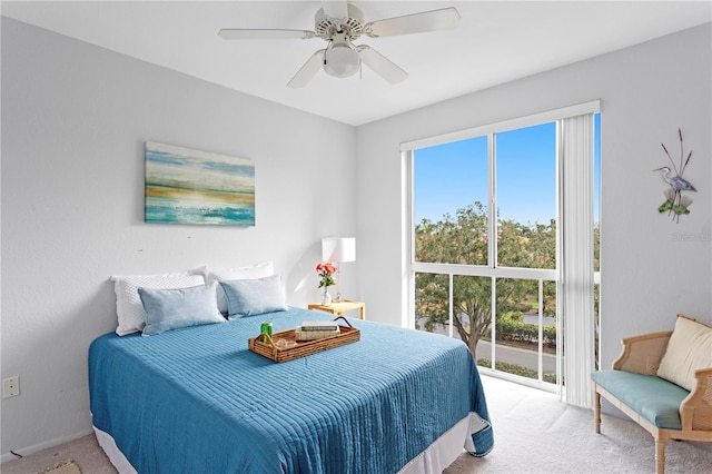 bedroom featuring light carpet, ceiling fan, and multiple windows