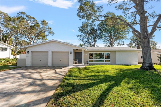 ranch-style home featuring a front yard and a garage