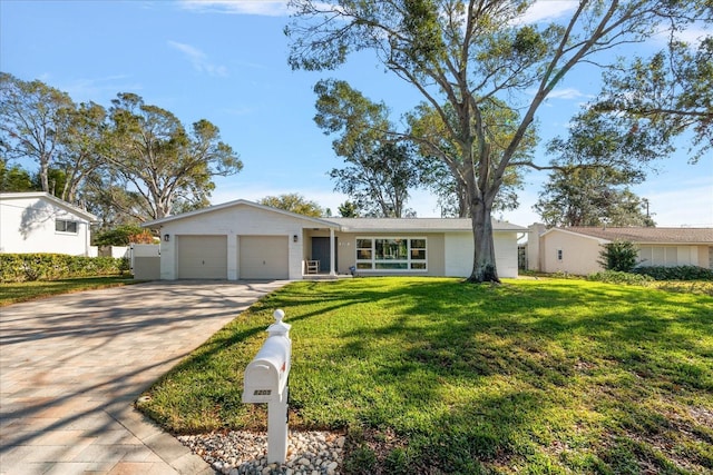 single story home with a front yard and a garage