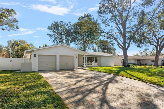 ranch-style home with a front yard and a garage