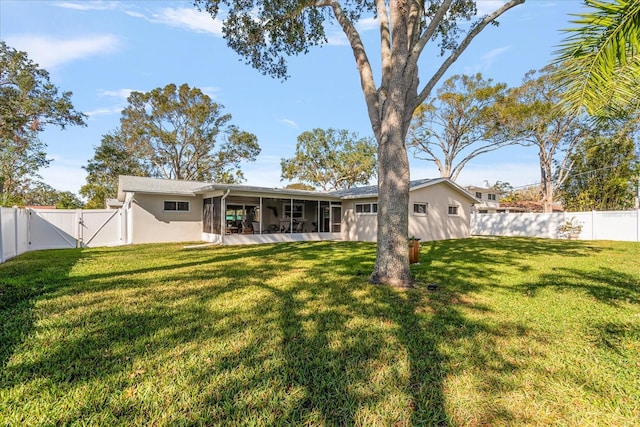 back of property featuring a yard and a sunroom