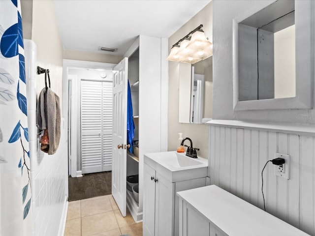 bathroom featuring walk in shower, tile patterned floors, and vanity