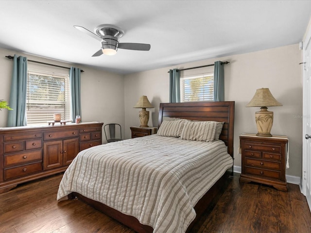 bedroom featuring multiple windows, dark hardwood / wood-style flooring, and ceiling fan