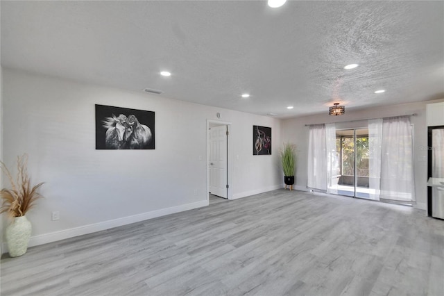 spare room featuring light hardwood / wood-style floors