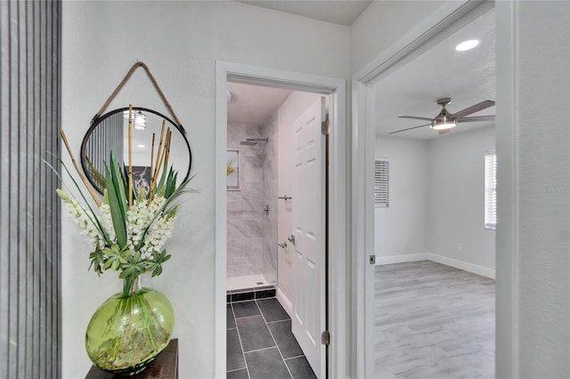 hallway with dark tile patterned flooring