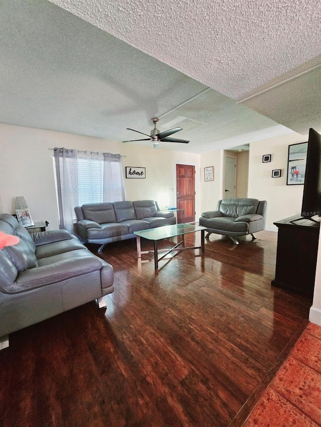 living room with hardwood / wood-style floors, a textured ceiling, and ceiling fan