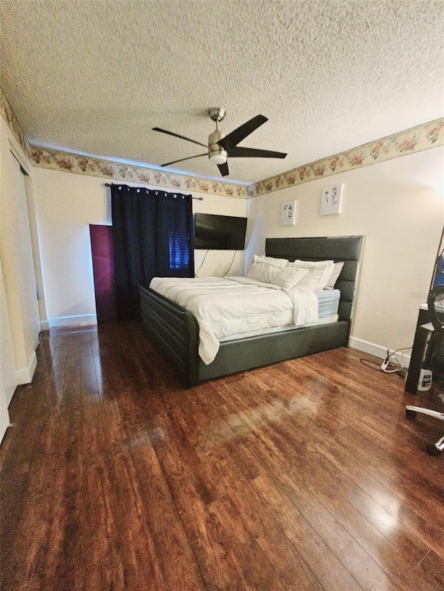 unfurnished bedroom with a textured ceiling, hardwood / wood-style flooring, and ceiling fan