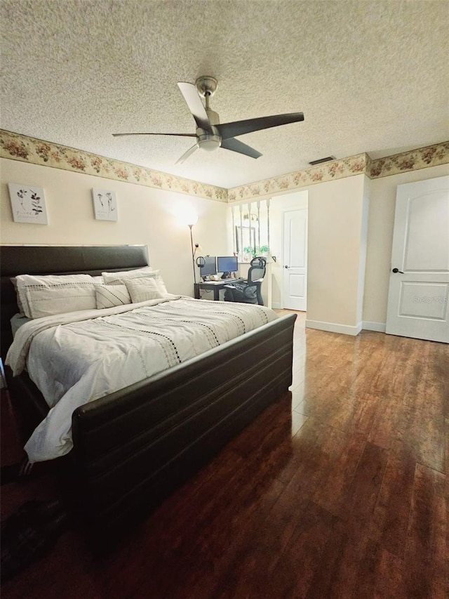 bedroom featuring hardwood / wood-style floors, ceiling fan, and a textured ceiling