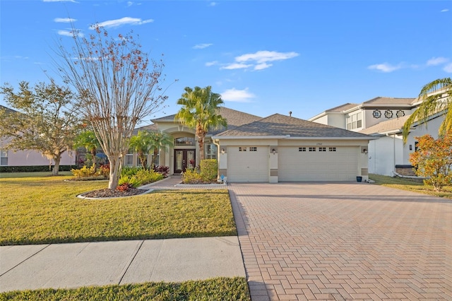 view of front of house with a garage and a front lawn