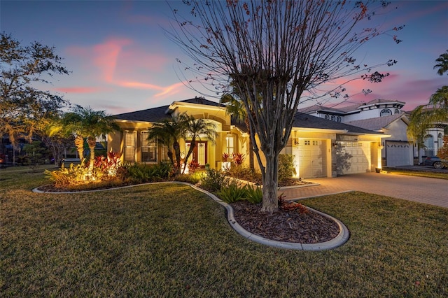 view of front of house with a garage and a yard