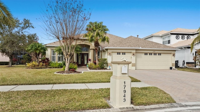 view of front of home with a garage and a front yard