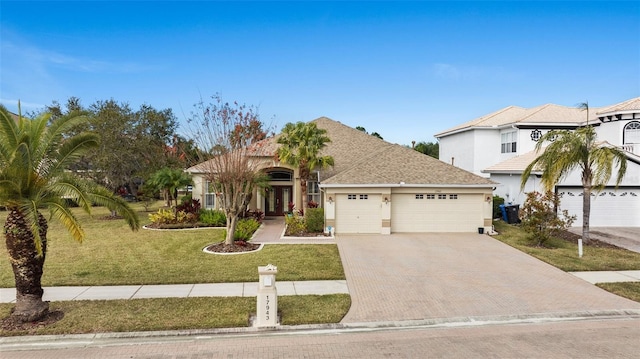 view of front of property featuring a garage and a front lawn