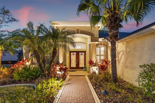 exterior entry at dusk with french doors