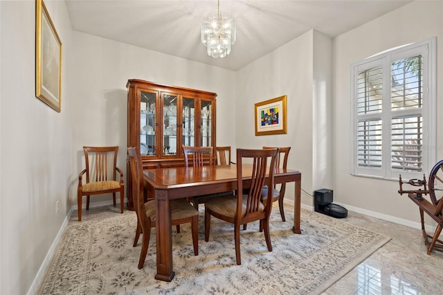 dining area featuring a notable chandelier