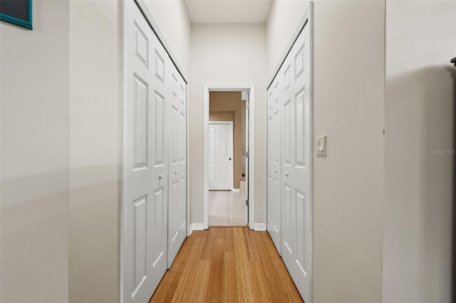 corridor with light wood-type flooring