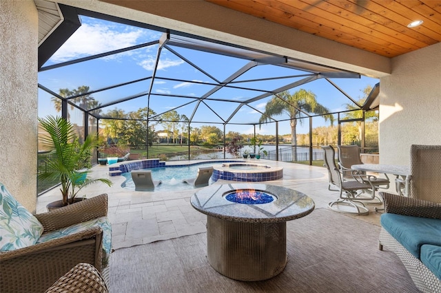 view of patio with a water view, pool water feature, a lanai, and a pool with hot tub