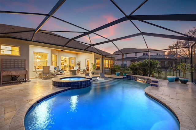 pool at dusk featuring an outdoor fireplace, an in ground hot tub, a lanai, and a patio