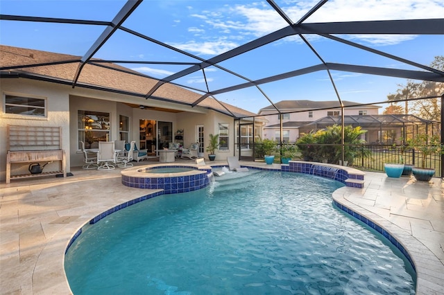 view of swimming pool featuring a fireplace, an in ground hot tub, pool water feature, glass enclosure, and a patio area