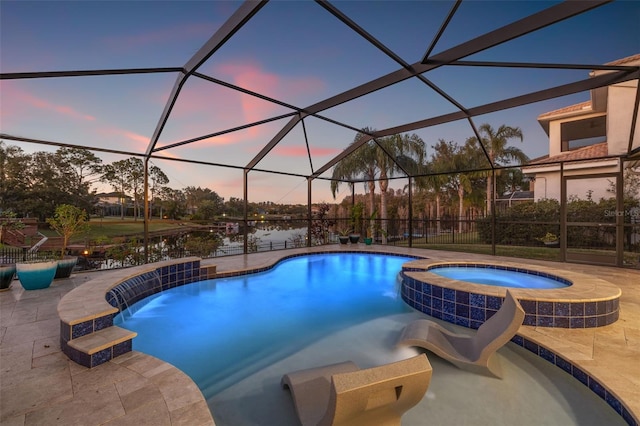 pool at dusk with a lanai, a patio area, an in ground hot tub, and a water view