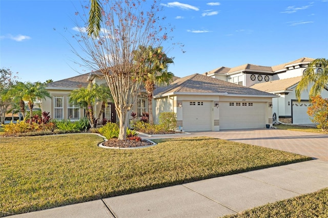 view of front of house featuring a garage and a front lawn