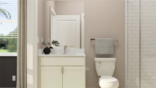 bathroom featuring vanity, toilet, and plenty of natural light