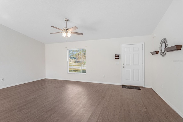 empty room with dark hardwood / wood-style floors and ceiling fan