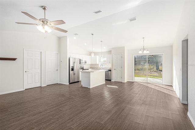 unfurnished living room featuring ceiling fan with notable chandelier, dark hardwood / wood-style floors, high vaulted ceiling, and sink