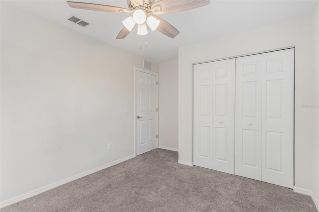 unfurnished bedroom featuring ceiling fan, a closet, and light colored carpet