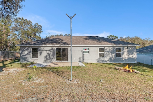 back of property featuring a lawn and a patio