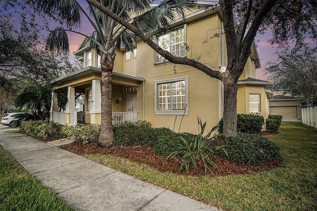 view of front of property with a lawn and a porch