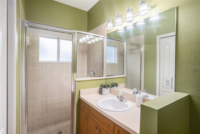 bathroom featuring vanity and an enclosed shower