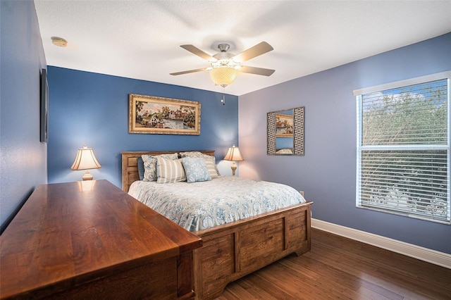 bedroom featuring dark hardwood / wood-style flooring and ceiling fan