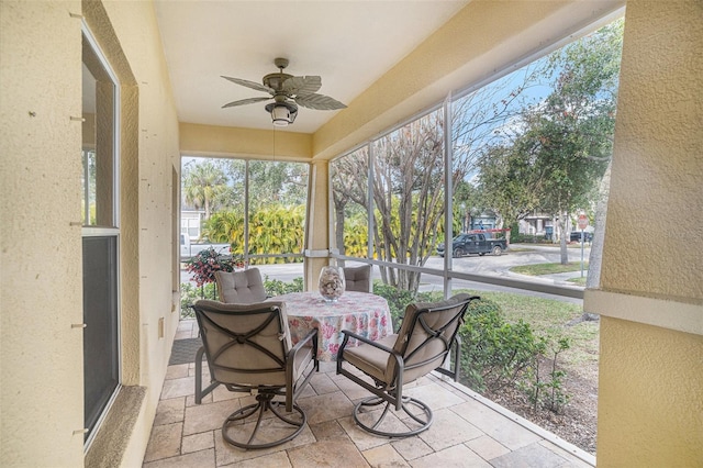 sunroom featuring ceiling fan