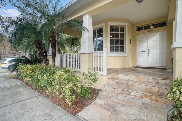 property entrance featuring a porch