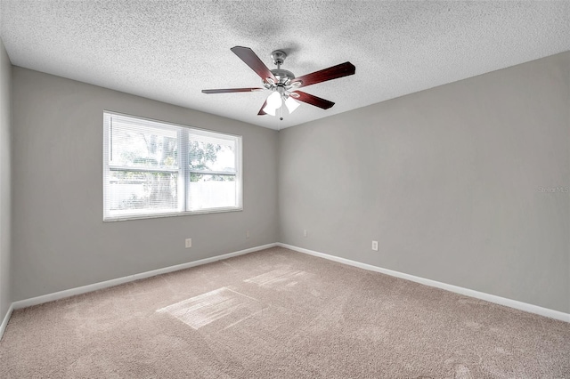 carpeted spare room with ceiling fan and a textured ceiling