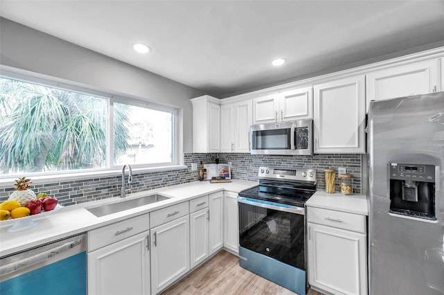 6311 Newtown Cir Unit 11B1, Tampa, FL 33615 - kitchen with appliances with stainless steel finishes, a sink, white cabinetry, light countertops, and recessed lighting