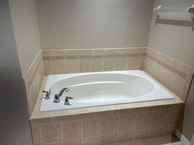 bathroom with a relaxing tiled tub