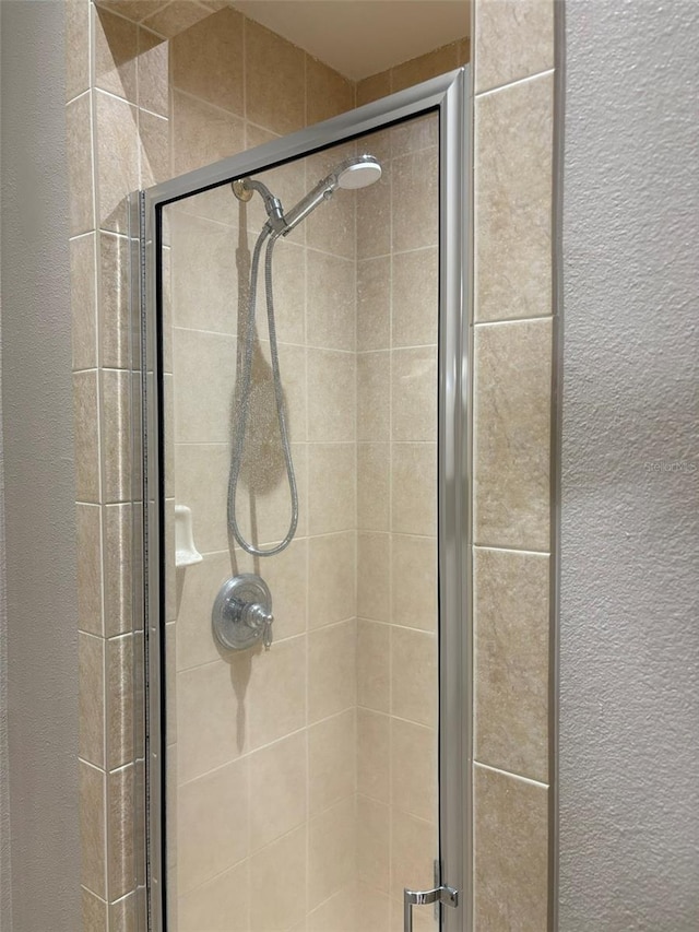 bathroom with a shower with door