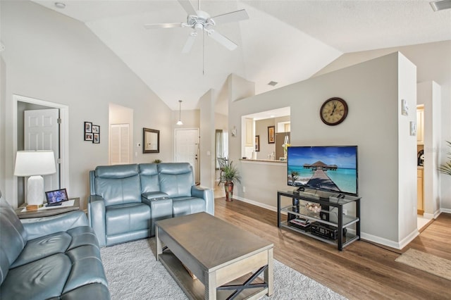 living room with lofted ceiling, ceiling fan, and hardwood / wood-style floors