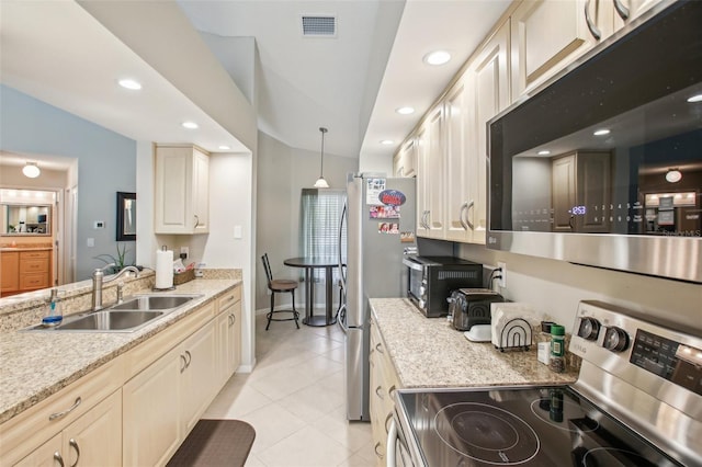 kitchen featuring lofted ceiling, stainless steel appliances, sink, hanging light fixtures, and light tile patterned flooring