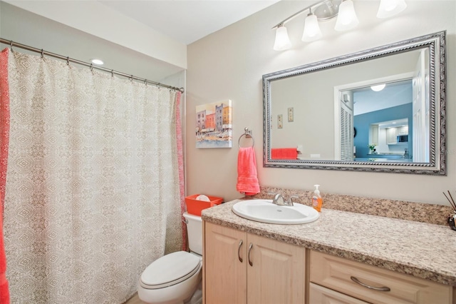 bathroom featuring toilet and vanity