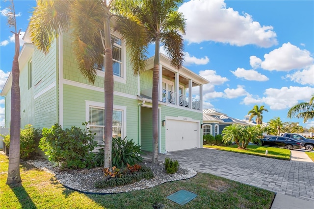 view of front of house featuring a balcony and a garage