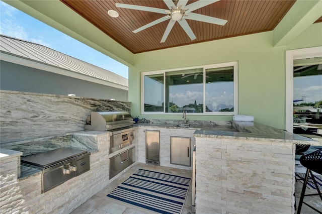 view of patio featuring area for grilling, ceiling fan, and sink