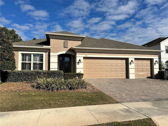 view of front of house featuring a front lawn and a garage