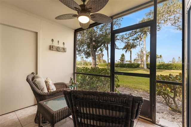 sunroom featuring ceiling fan