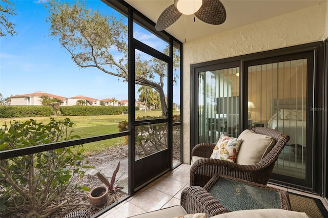 sunroom featuring ceiling fan