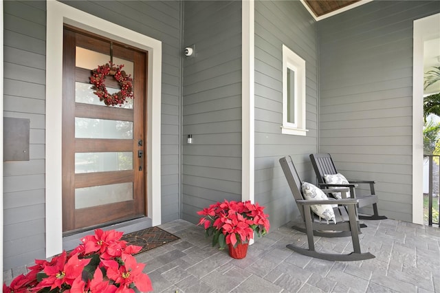 view of exterior entry featuring a porch