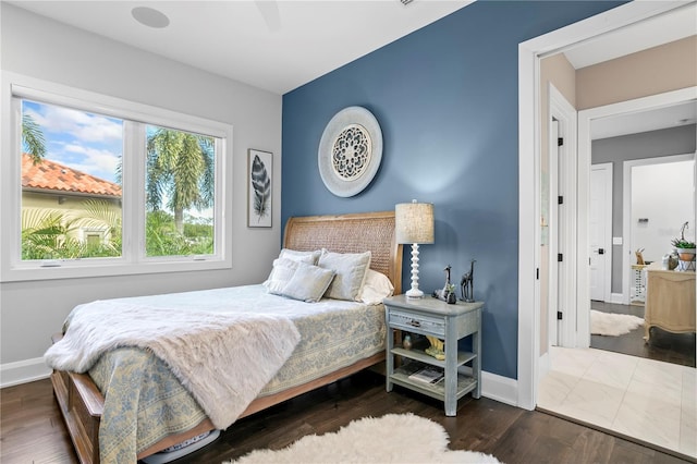 bedroom featuring ceiling fan and dark hardwood / wood-style flooring